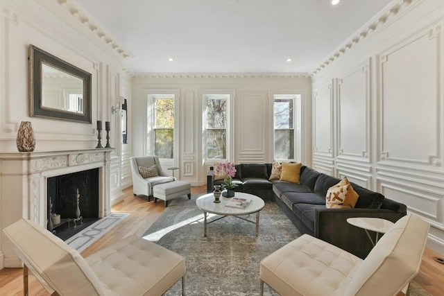 65 Marlborough St Unit 1-6, Boston, MA 02116 - living area with a decorative wall, plenty of natural light, light wood finished floors, crown molding, and a high end fireplace