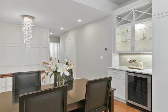 65 Marlborough St Unit 1-6, Boston, MA 02116 - dining area featuring beverage cooler, a bar, light wood-type flooring, and recessed lighting