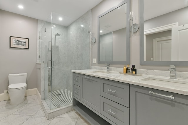 bathroom featuring vanity, toilet, and a shower with shower door