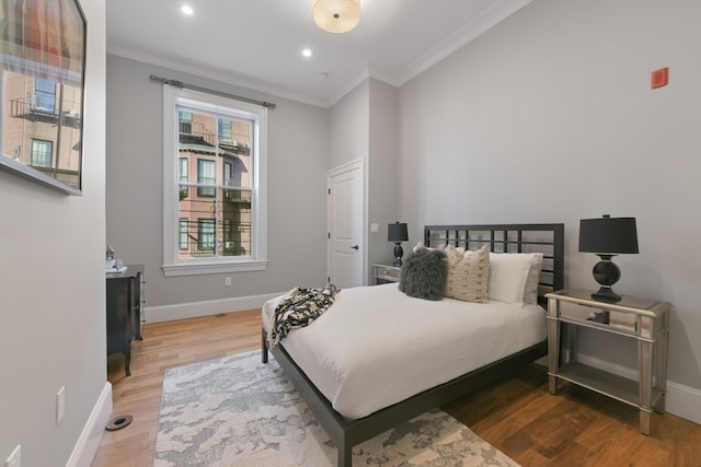 bedroom featuring hardwood / wood-style floors and crown molding