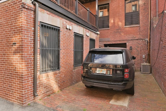 view of side of property featuring a garage and cooling unit