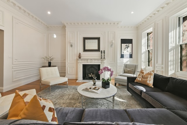 living room featuring hardwood / wood-style flooring and crown molding