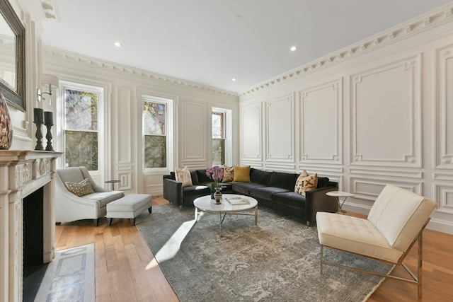 living room with hardwood / wood-style floors and crown molding