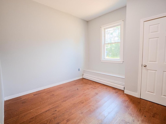 461 Aiken Ave, Dracut, MA 01826 - empty room featuring a baseboard radiator and wood finished floors
