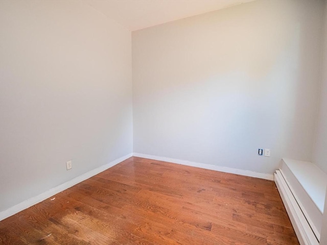 461 Aiken Ave, Dracut, MA 01826 - empty room featuring a baseboard radiator and wood finished floors