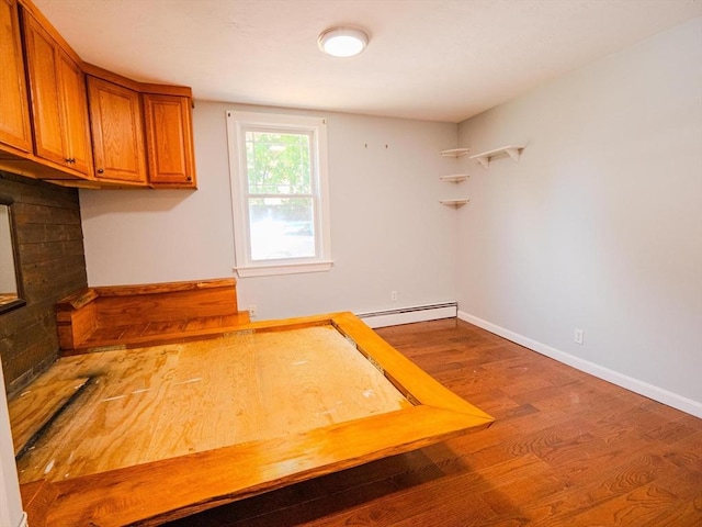 461 Aiken Ave, Dracut, MA 01826 - kitchen featuring brown cabinetry, a baseboard radiator, and wood finished floors