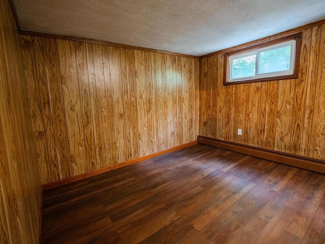 461 Aiken Ave, Dracut, MA 01826 - unfurnished room with a baseboard radiator, wood finished floors, a textured ceiling, and wooden walls