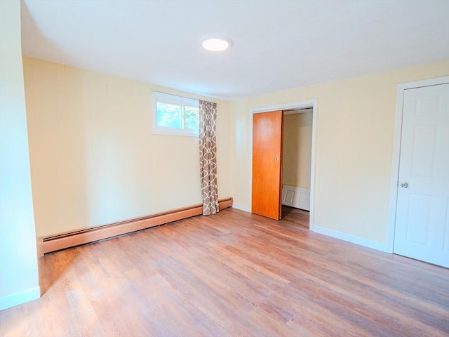 461 Aiken Ave, Dracut, MA 01826 - unfurnished bedroom featuring baseboard heating, wood finished floors, and a closet