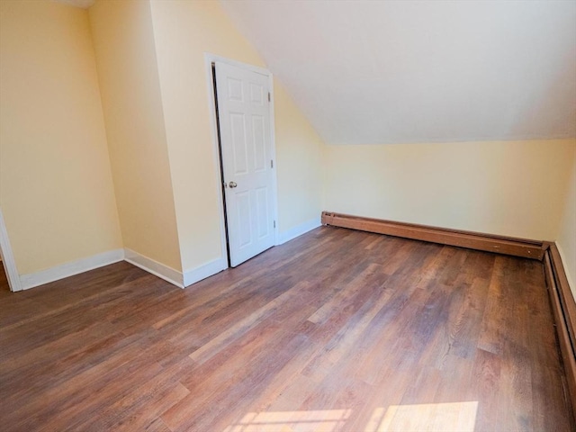 461 Aiken Ave, Dracut, MA 01826 - additional living space with a baseboard radiator, vaulted ceiling, and wood finished floors