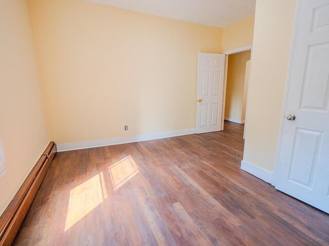 461 Aiken Ave, Dracut, MA 01826 - empty room featuring a baseboard radiator and wood finished floors