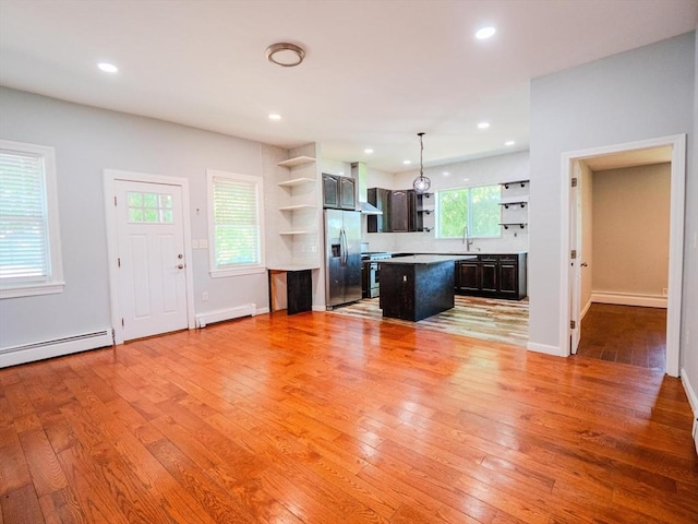 461 Aiken Ave, Dracut, MA 01826 - unfurnished living room with a baseboard radiator, light wood-style floors, and recessed lighting