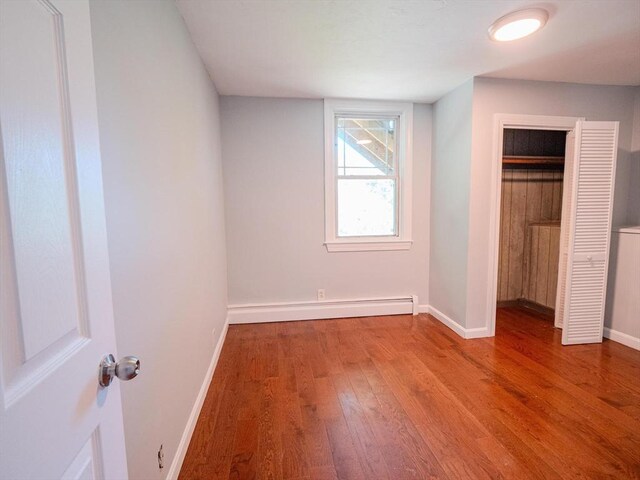 461 Aiken Ave, Dracut, MA 01826 - unfurnished bedroom with wood finished floors and baseboard heating