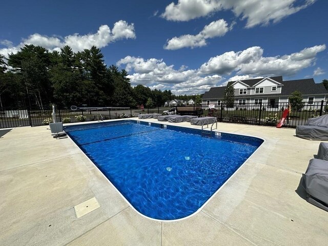 view of swimming pool featuring a patio area