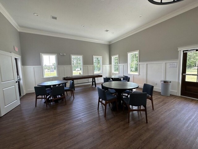 dining room featuring plenty of natural light, wood-type flooring, and ornamental molding