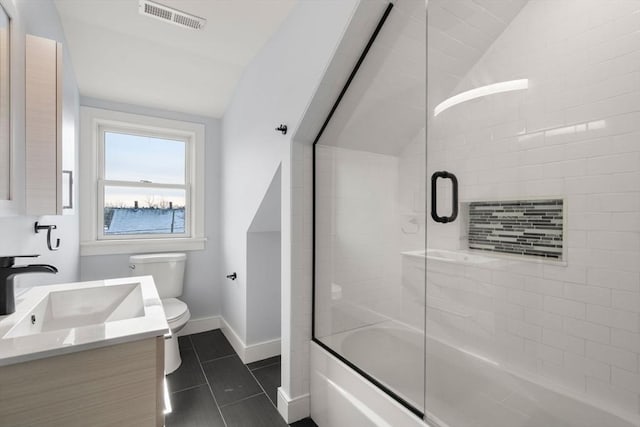 167 Charles St, Waltham, MA 02453 - bathroom with lofted ceiling, toilet, tile patterned floors, vanity, and baseboards