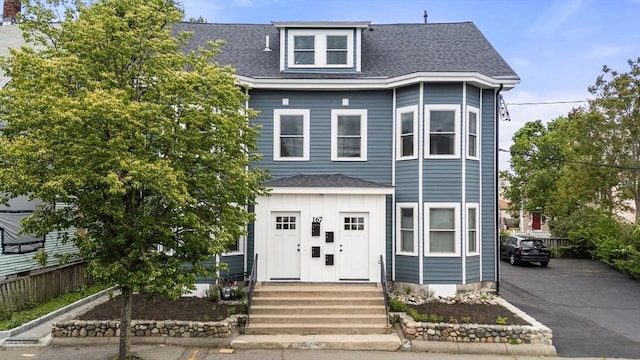 167 Charles St, Waltham, MA 02453 - view of front of home featuring a shingled roof and board and batten siding