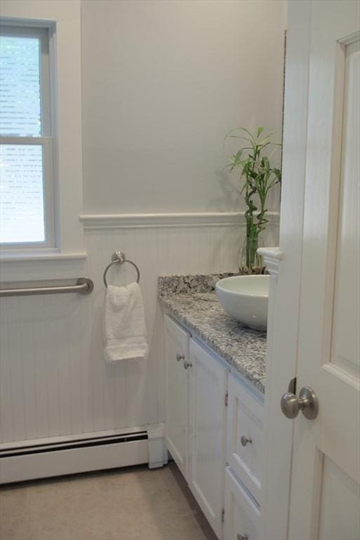 bathroom featuring a wainscoted wall, a baseboard radiator, and vanity