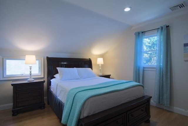 bedroom with light wood-style floors, baseboards, and visible vents