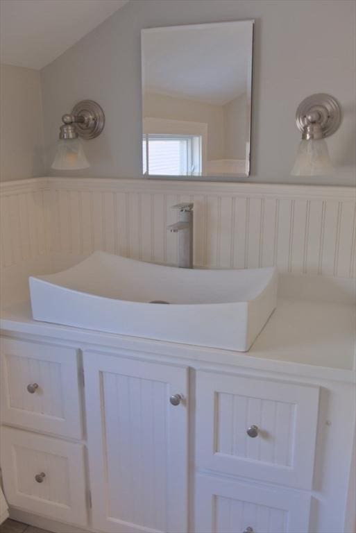 bathroom with wainscoting and a sink