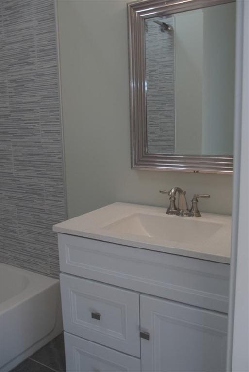 full bathroom with tile patterned flooring and vanity