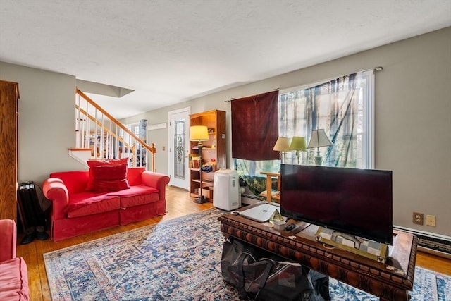 living room featuring light hardwood / wood-style floors and baseboard heating