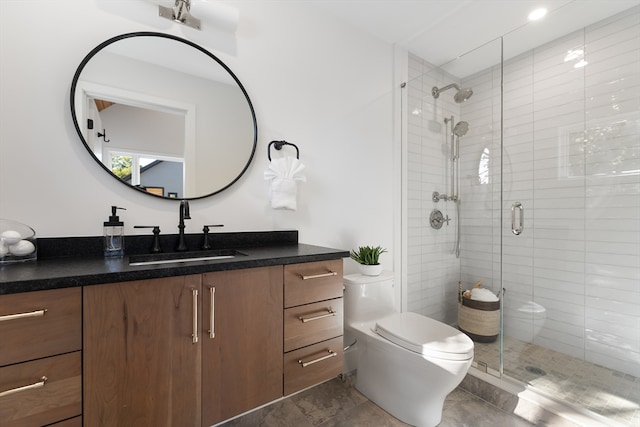 bathroom with a shower with shower door, toilet, and vanity