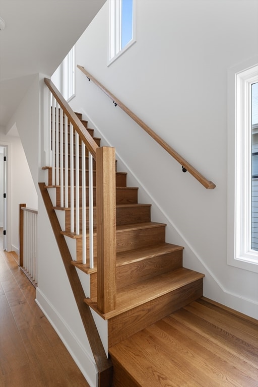 stairs featuring hardwood / wood-style floors