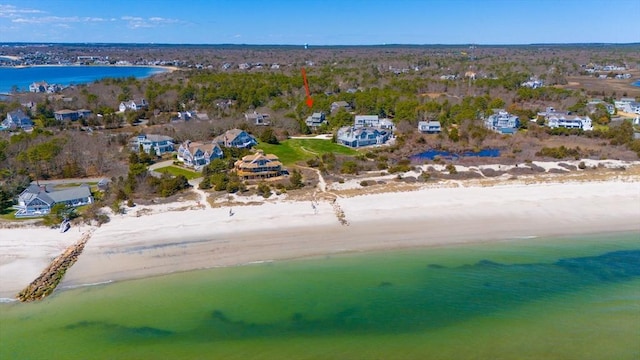 birds eye view of property featuring a water view and a view of the beach