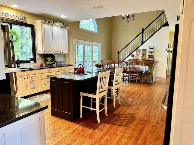 6 Everett Cir, Hopkinton, MA 01748 - kitchen featuring a breakfast bar, light wood-type flooring, recessed lighting, a center island, and a sink