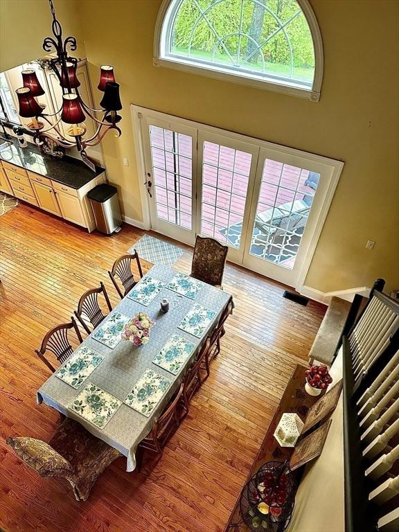 6 Everett Cir, Hopkinton, MA 01748 - dining space featuring a high ceiling, baseboards, and hardwood / wood-style floors