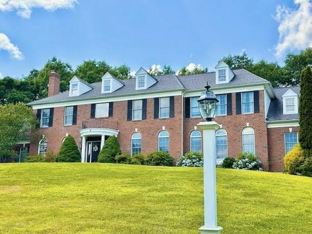 6 Everett Cir, Hopkinton, MA 01748 - colonial-style house featuring a chimney, a front yard, and brick siding