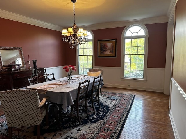 6 Everett Cir, Hopkinton, MA 01748 - dining area with crown molding, wood finished floors, an inviting chandelier, and wainscoting
