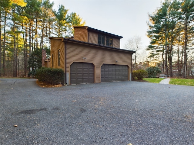 view of side of home featuring a garage