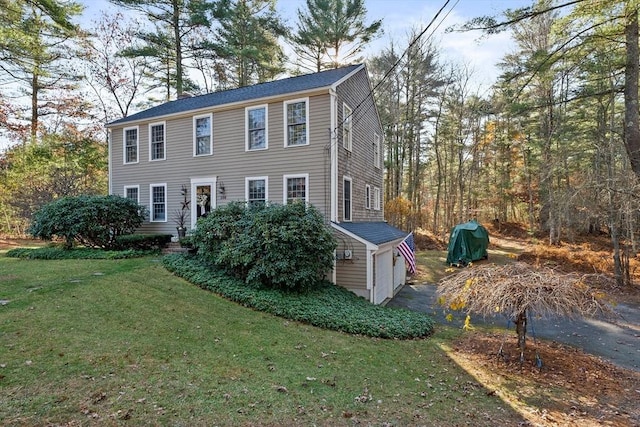 view of front of home featuring a garage and a front lawn