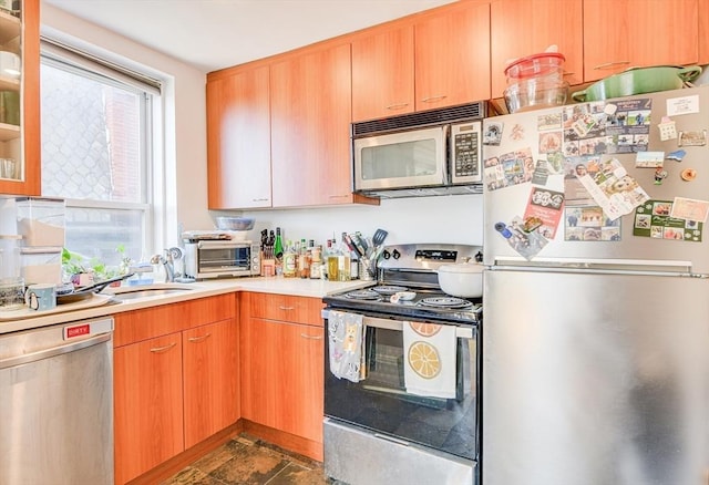 492 Massachusetts Ave Unit 53, Boston, MA 02118 - kitchen featuring stainless steel appliances, light countertops, and glass insert cabinets