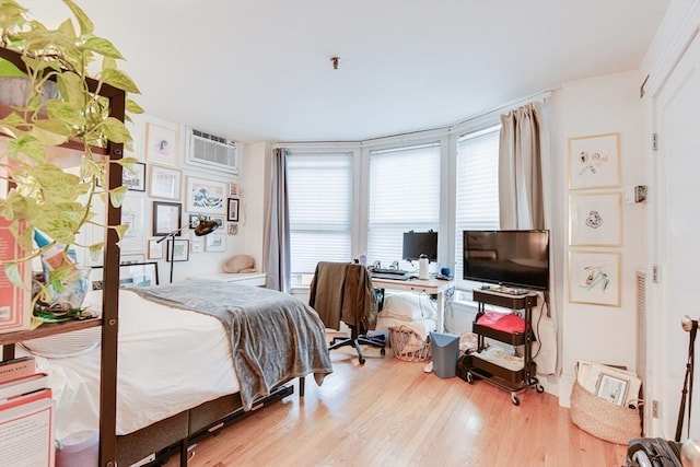 492 Massachusetts Ave Unit 53, Boston, MA 02118 - bedroom featuring wood finished floors, a desk, and a wall mounted air conditioner