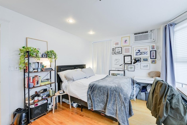 492 Massachusetts Ave Unit 53, Boston, MA 02118 - bedroom featuring an AC wall unit, light wood-style flooring, and recessed lighting