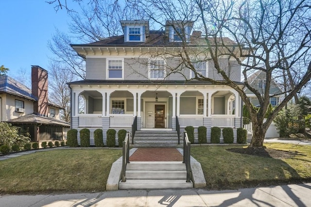 view of front of home with covered porch and a front yard