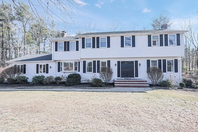 colonial inspired home with a chimney