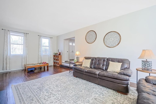 living room with baseboards and wood finished floors