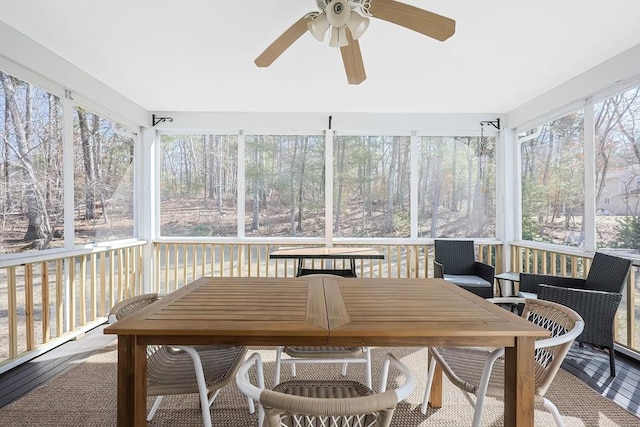 sunroom / solarium featuring ceiling fan