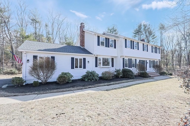 colonial inspired home with a chimney