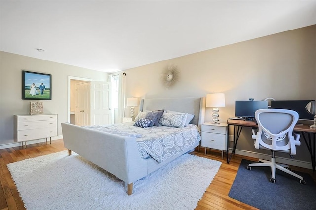 bedroom with baseboards and wood finished floors