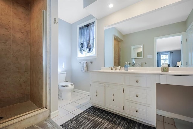 bathroom with baseboards, toilet, a stall shower, tile patterned floors, and vanity