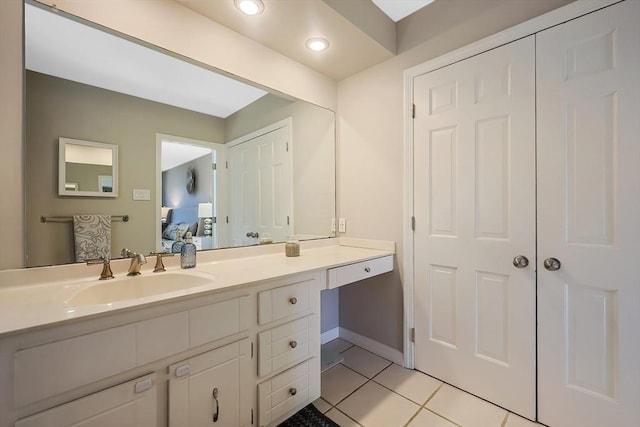 ensuite bathroom with vanity, baseboards, recessed lighting, tile patterned flooring, and ensuite bathroom