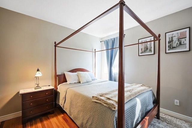 bedroom featuring baseboards and wood finished floors