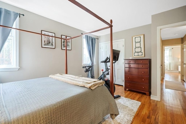 bedroom featuring light wood-type flooring and baseboards