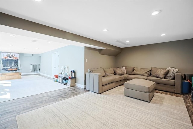 living room featuring recessed lighting, light wood-type flooring, and baseboards