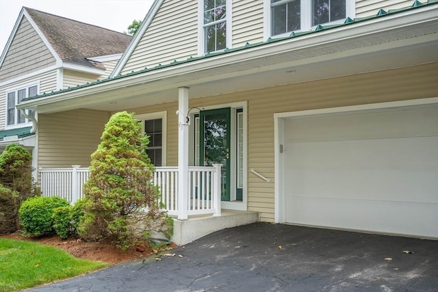 43 Blossom Sq Unit 43, Holden, MA 01520 - doorway to property featuring a garage, covered porch, and asphalt driveway