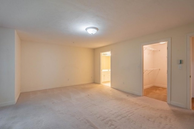 43 Blossom Sq Unit 43, Holden, MA 01520 - unfurnished bedroom featuring a spacious closet, light carpet, ensuite bathroom, and a closet